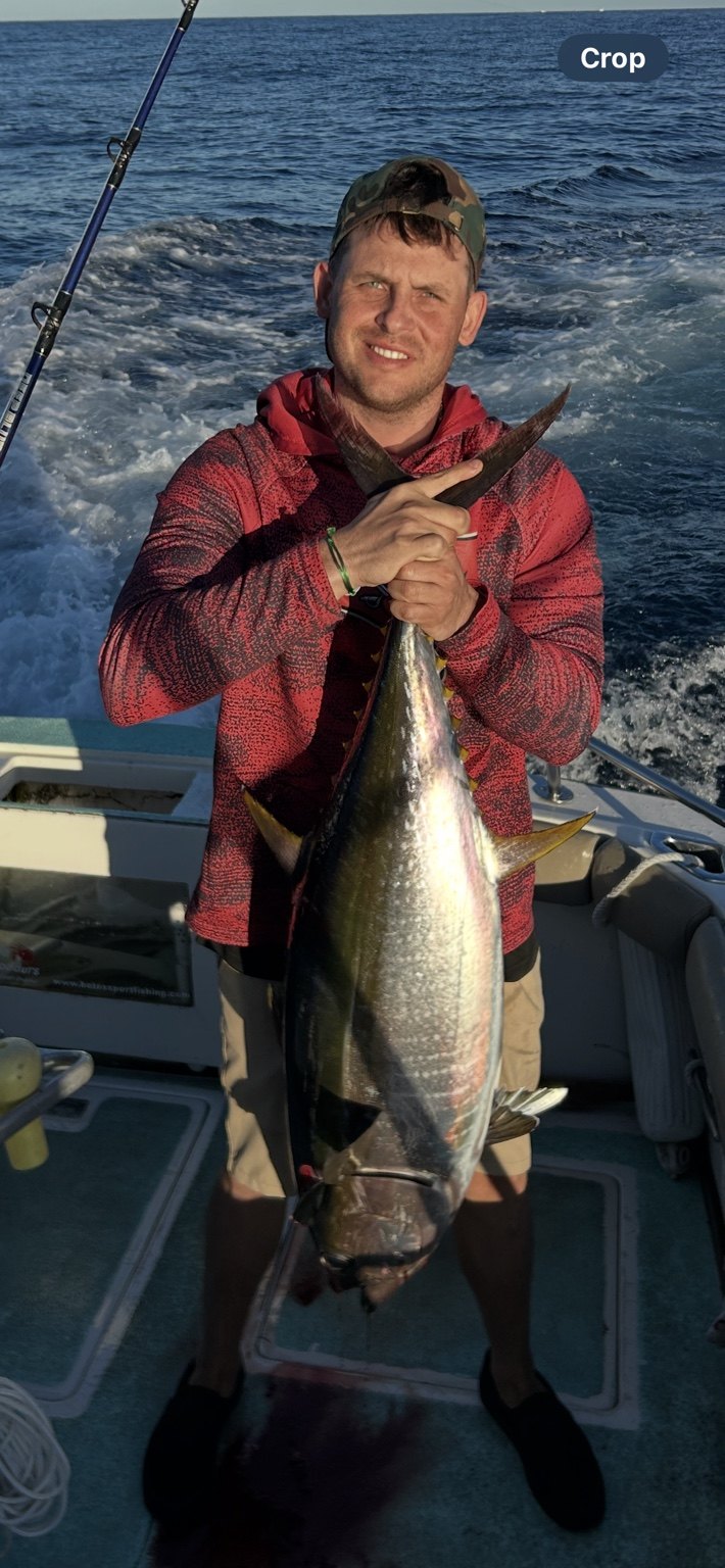 Angler with a tuna catch on the water